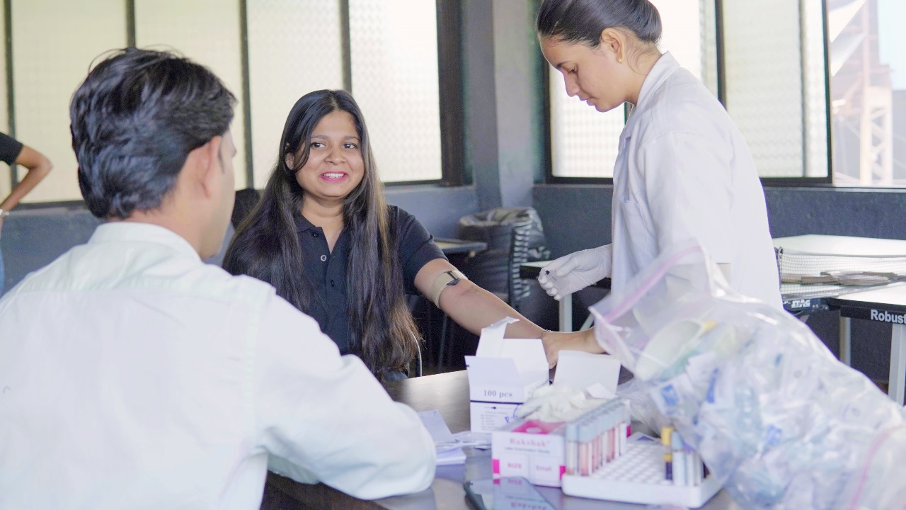 Medical professional conducting blood test for employee